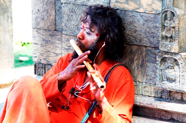 Sadhu playing flute.